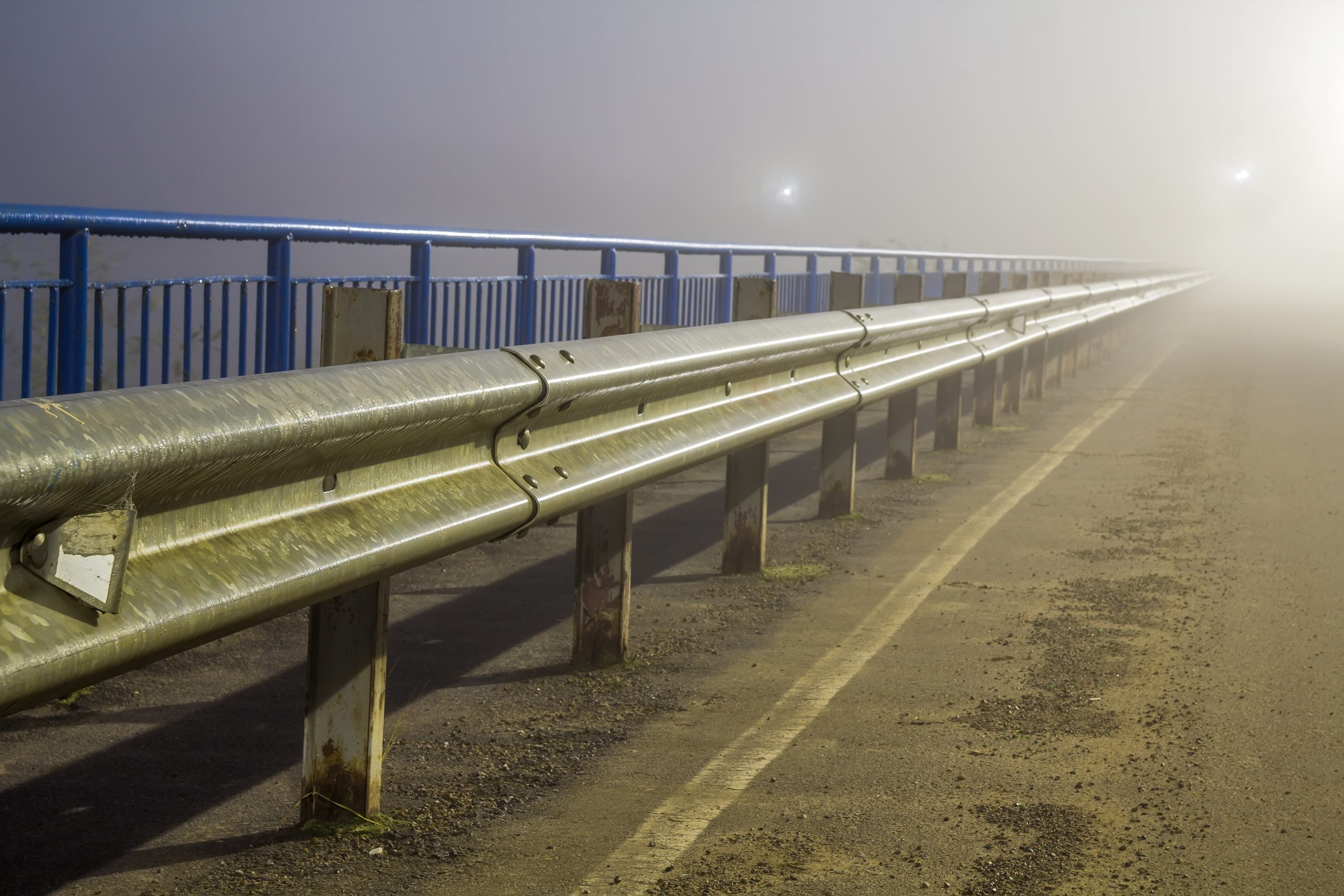Thick fog over empty road at night